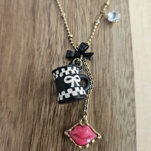 Betsey Johnson necklace with coffee mug, pink lips, jewel, heart, and bow charms
